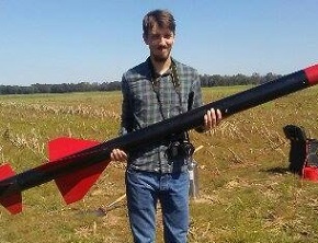 Brandon Gusto holding a rocket we launched in Sampson Alabama